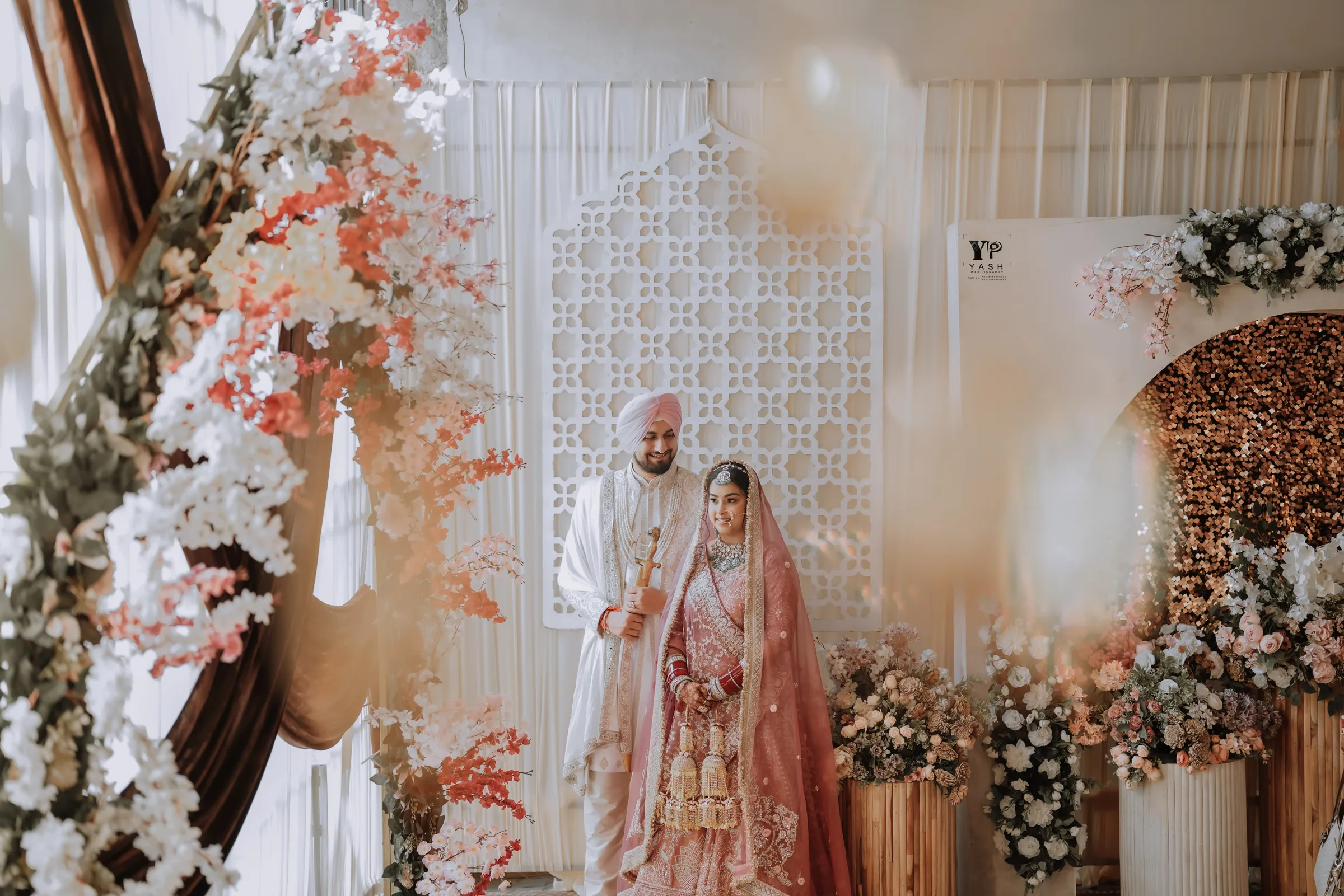 Couple at their floral wedding stage